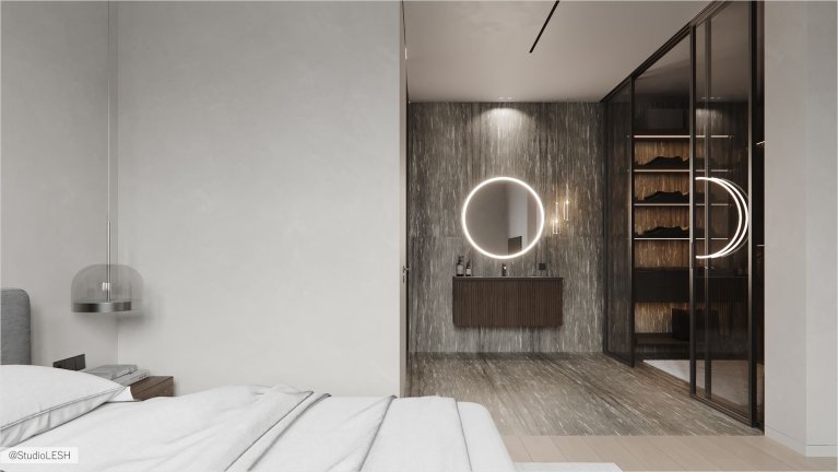 Интерьер современной спальни: кровать с мягким изголовьем из ткани серого цвета, две прикроватные тумбочки с выдвижными ящиками, серый ковер на полу, светлые стены.