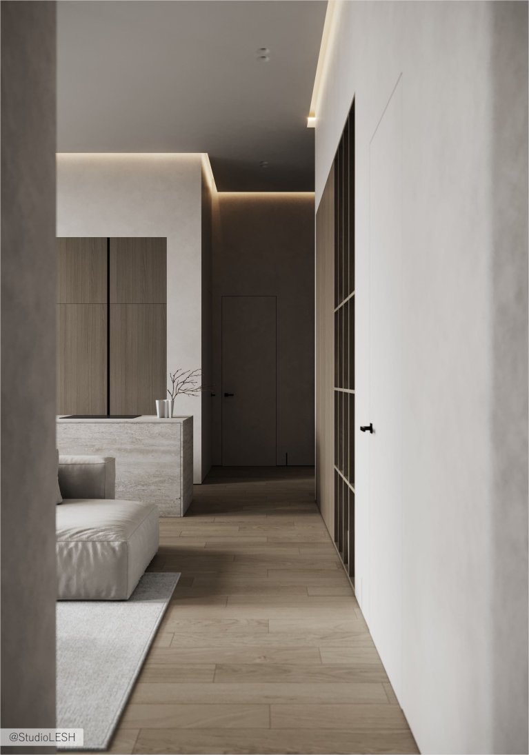 Интерьер современной прихожей с белыми стенами, деревянным полом, встроенным шкафом с деревянными фасадами и мягким диваном.