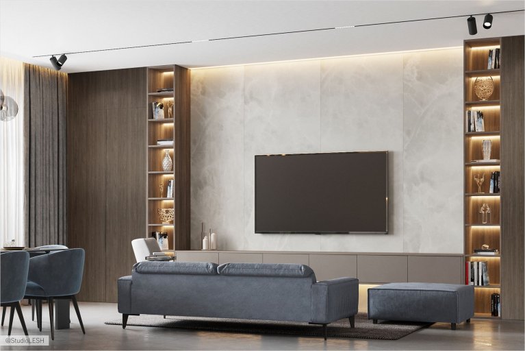 Гостиная встречает нас своей лаконичностью и уютом. Светлые тона стен и пола визуально расширяют пространство, а удобный диван приглашает к отдыху. Телевизор на стене создает возможность для просмотра фильмов и передач, а подсветка добавляет комфорта и уюта