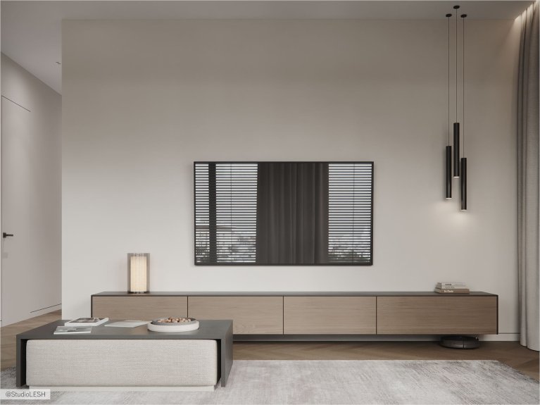 Стильная гостиная с плоским телевизором на стене, длинной тумбой под ним, и минималистичными чёрными светильниками. В комнате также есть серый диван, кофейный столик и серая дорожка на полу