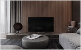 TV in the living room with a coffee ottoman